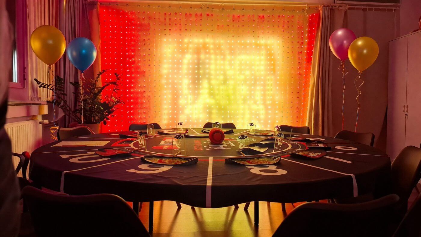 Birthday table decorated with balloons and lights
