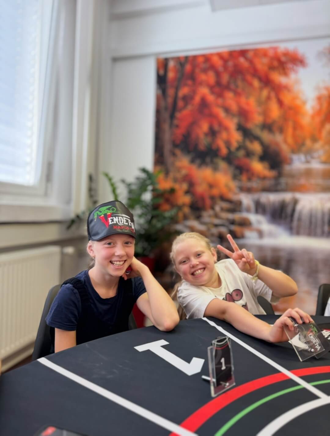 Kids at mafia table with Vendetta cap