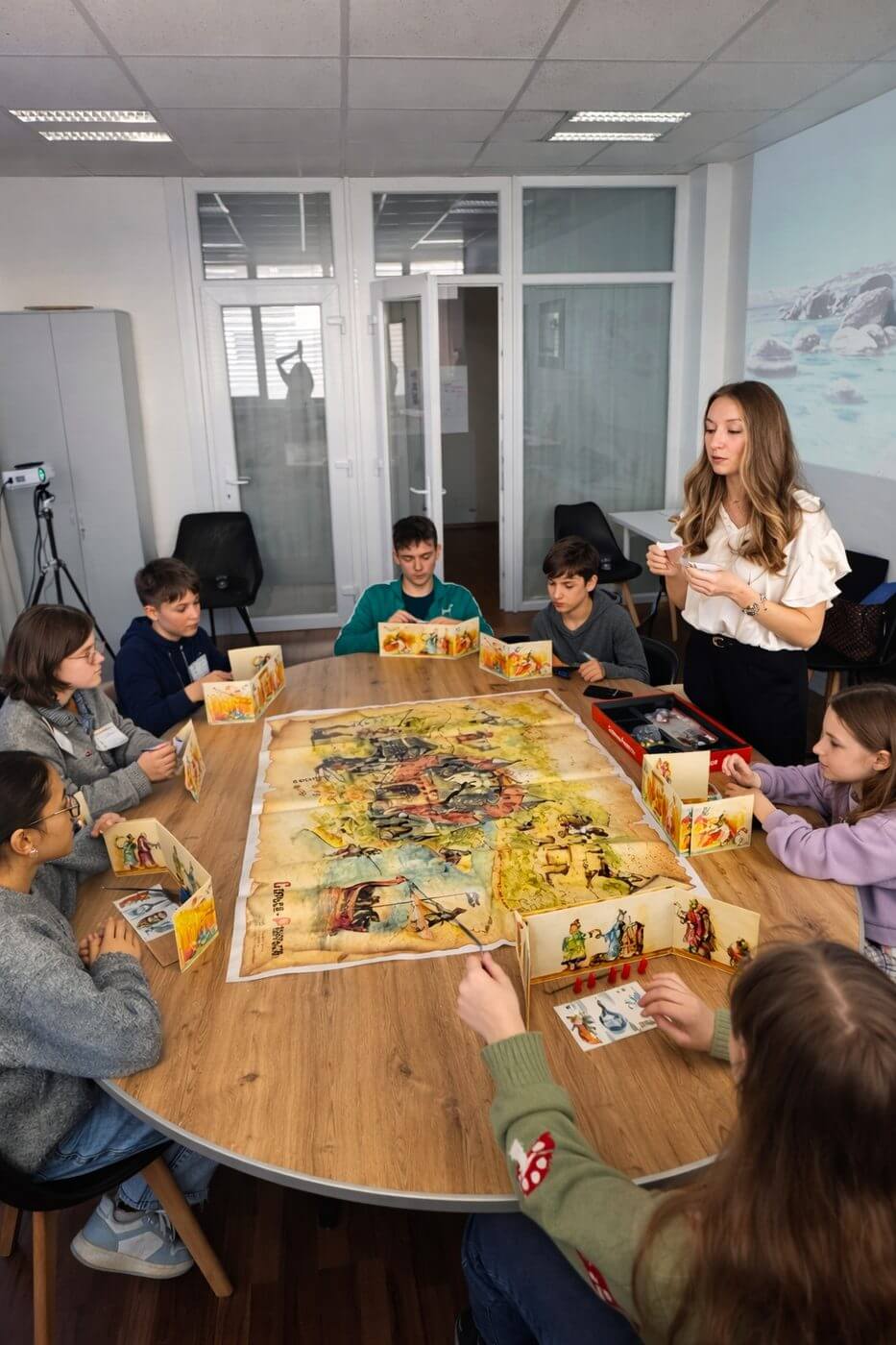 Kids with board game and host
